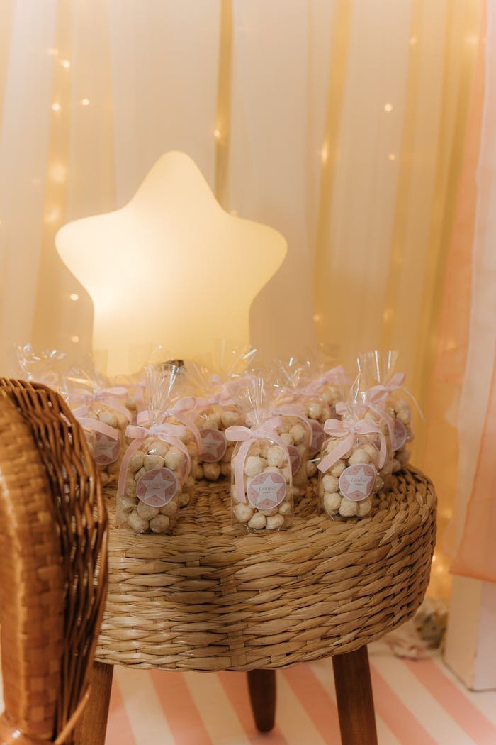 services-02 Star-shaped light with party favors on a wicker table creates a magical birthday setting.